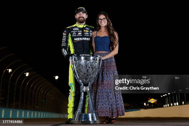 Ryan Blaney, driver of the Menards/Dutch Boy Ford, and Gianna Tulio pose with the Bill France NASCAR Cup Series Championship trophy after winning the...