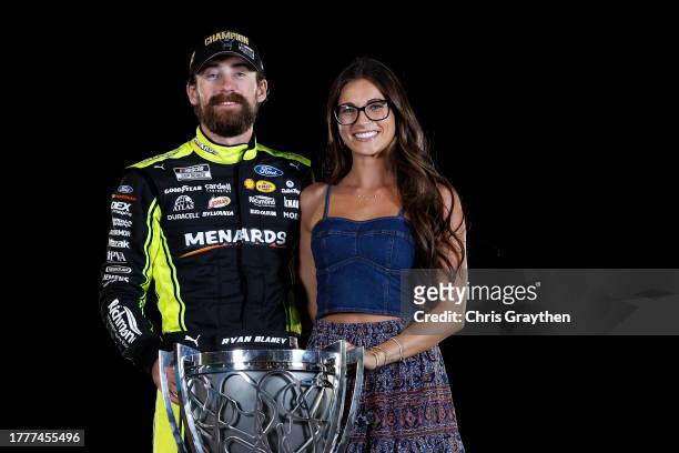 Ryan Blaney, driver of the Menards/Dutch Boy Ford, and Gianna Tulio pose with the Bill France NASCAR Cup Series Championship trophy after winning the...