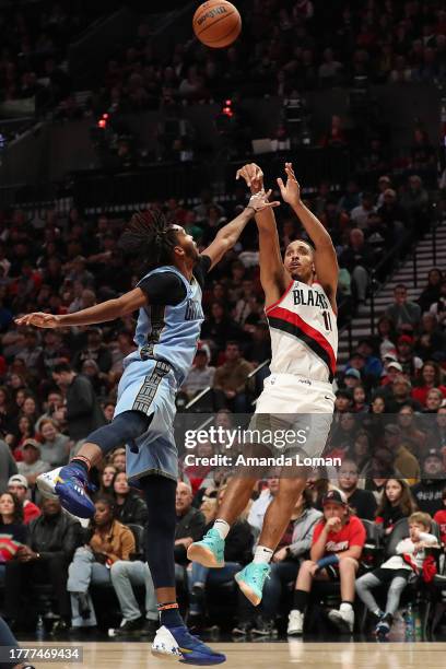 Malcolm Brogdon of the Portland Trail Blazers shoots over Ziaire Williams of the Memphis Grizzlies during the third quarter at Moda Center on...