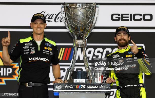 Ryan Blaney, driver of the Menards/Dutch Boy Ford, and crew chief Jonathan Hassler celebrate in victory lane after winning the 2023 NASCAR Cup Series...