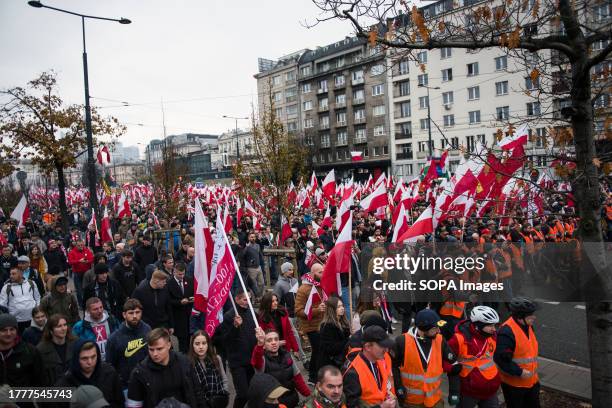 Participants are seen waving Polish flags during the Independence March in Warsaw. Poland's National Independence Day marks the anniversary of the...