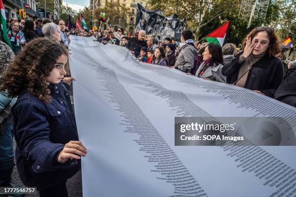 Woman is seen crying in front of her daughter, both carrying a large list of names of those killed by bombs during the demonstration. Some 7,500...