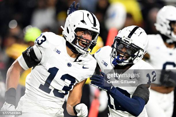 Tony Rojas of the Penn State Nittany Lions celebrates with Zion Tracy after making an interception against the Maryland Terrapins at SECU Stadium on...