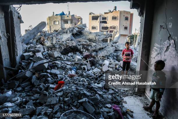 Children stand in a building, destroyed during Israeli air raids in the southern Gaza Strip on November 6, 2023 in Khan Yunis, Gaza. The Israeli army...