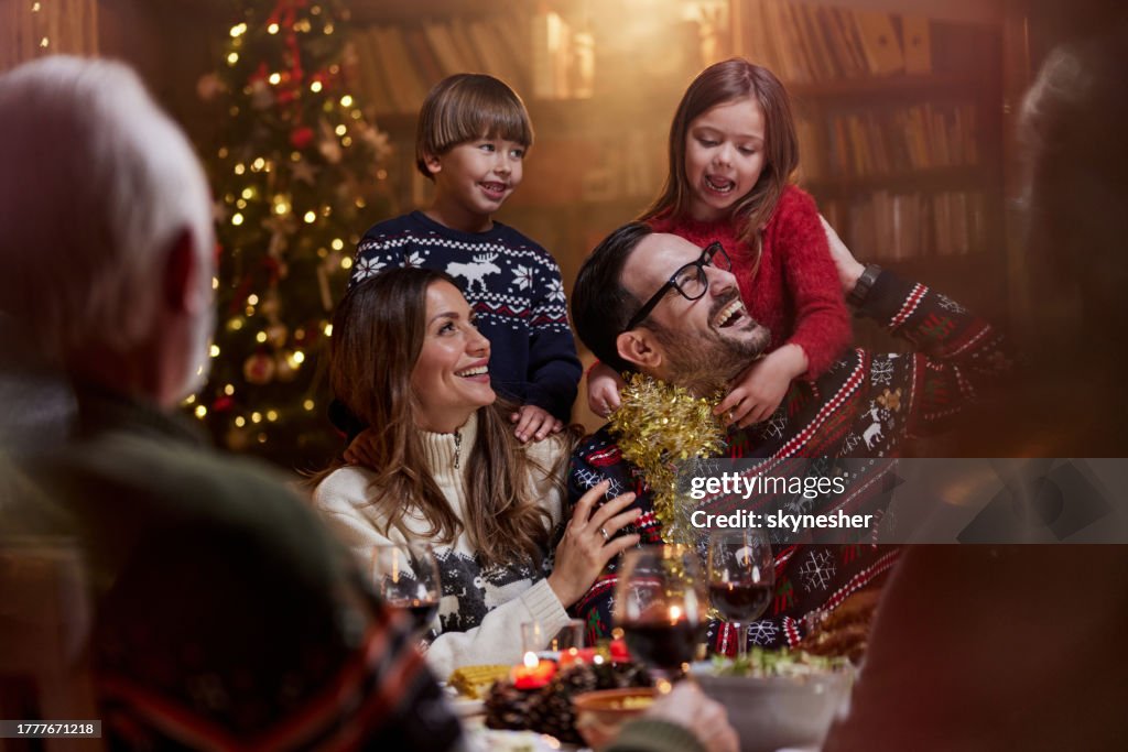 Happy family enjoying in New Year's dinner at grandparents'.