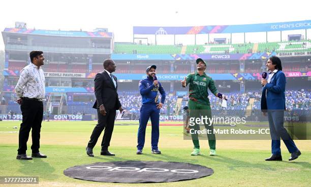 Shakib Al Hasan of Bangladesh flips the coin as Kusal Mendis of Sri Lanka looks on ahead of the ICC Men's Cricket World Cup India 2023 between...