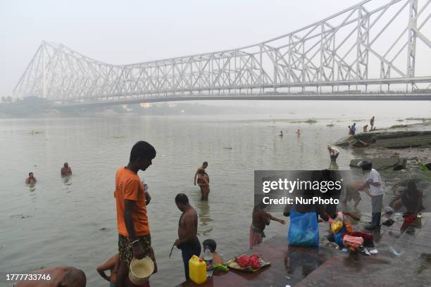 People are bathing in the Ganges river in the hazed morning at Kolkata, India on 12 November 2023. In India, Kolkata is the third most air-polluted...