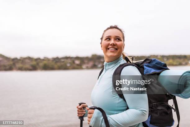 chubby woman's nature exploration by the river - springtime exercise stock pictures, royalty-free photos & images