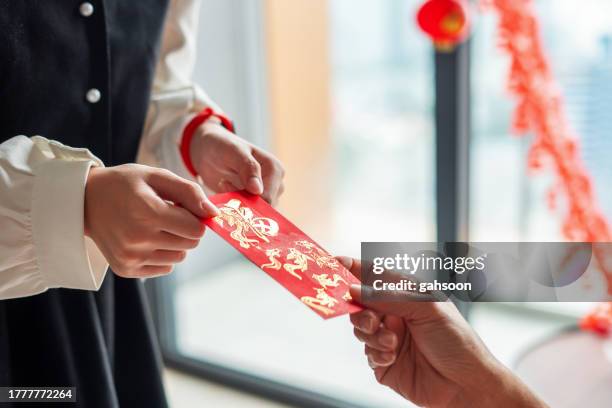 close up of hongbao (red envelope) gift during chinese new year - hong kong new year stock pictures, royalty-free photos & images