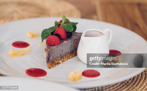 dairy free raw vegan nuts cake with berries and seeds. healthy dessert for gluten free dieting. - cashew pieces stock pictures, royalty-free photos & images