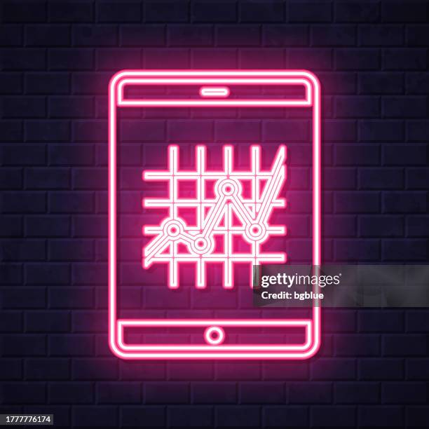 tablet pc with graph. glowing neon icon on brick wall background - touch screen wall stock illustrations