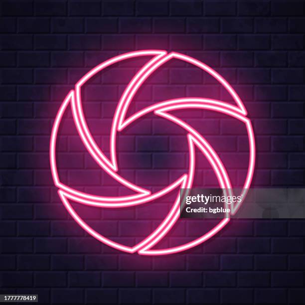 camera shutter. glowing neon icon on brick wall background - opening shutter stock illustrations