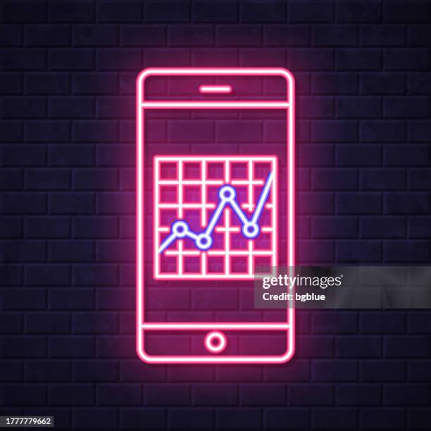 smartphone with graph. glowing neon icon on brick wall background - measuring height on wall stock illustrations