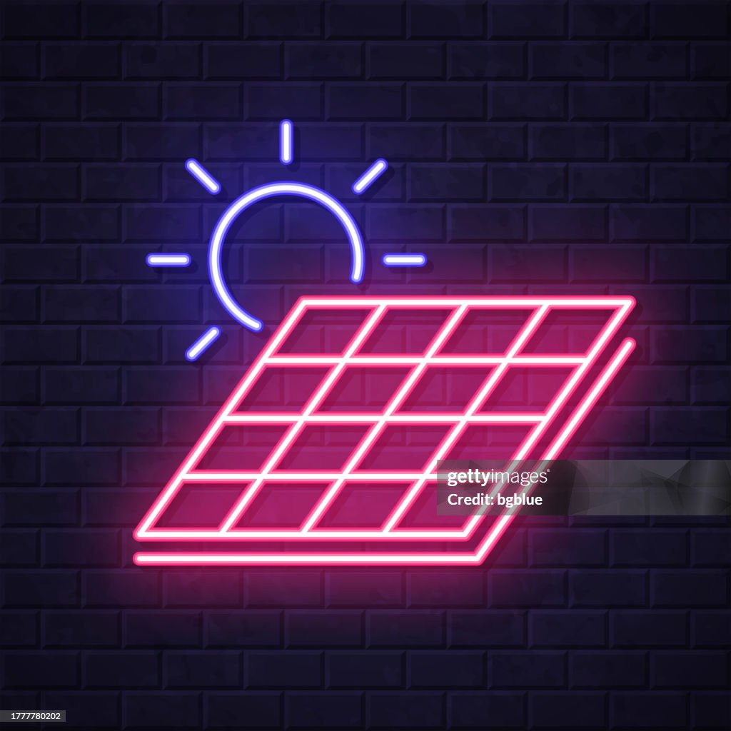 Solar panel with sun. Glowing neon icon on brick wall background
