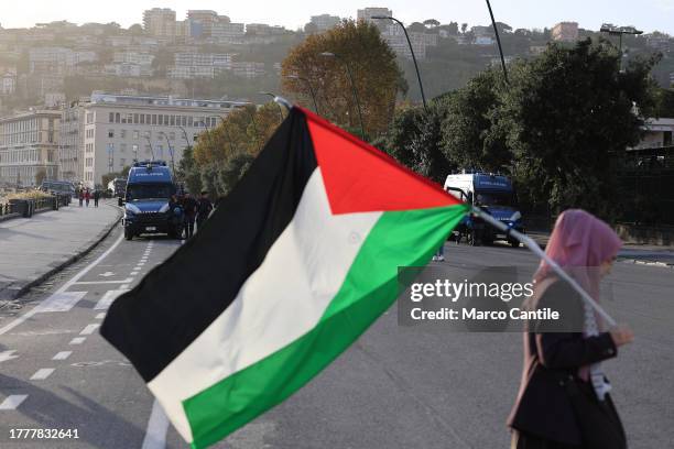 Woman with a Palestinian flag, during the demonstration in Naples in solidarity with the Palestinian people after Israel's attacks on the Gaza strip,...