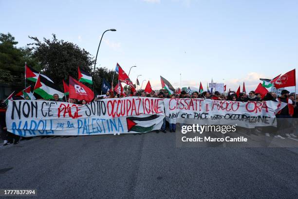 People with flags and a two banners, during the demonstration in Naples in solidarity with the Palestinian people after Israel's attacks on the Gaza...