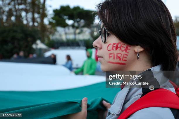 Woman with a writing on her cheek, during the demonstration in Naples in solidarity with the Palestinian people after Israel's attacks on the Gaza...