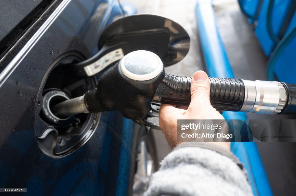 A man is pouring gas into the car. Austria