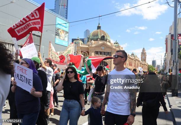 Around 100 thousand people, holding banners and Palestinian flags, gather in front of State Library Victoria to stage a pro-Palestinian demonstration...