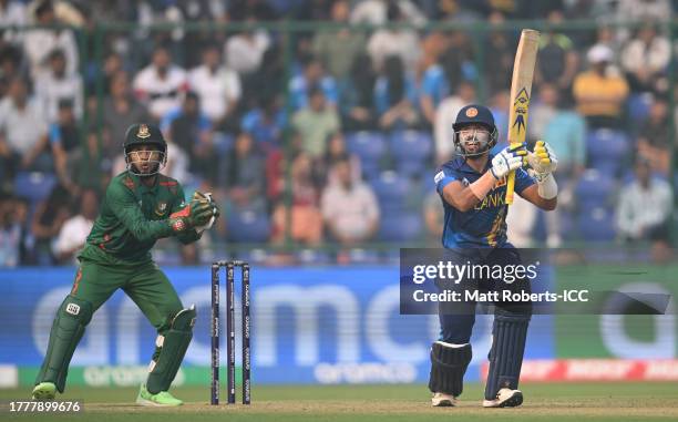 Sadeera Samarawickrama of Sri Lanka plays a shot as Mushfiqur Rahim of Bangladesh keeps during the ICC Men's Cricket World Cup India 2023 between...