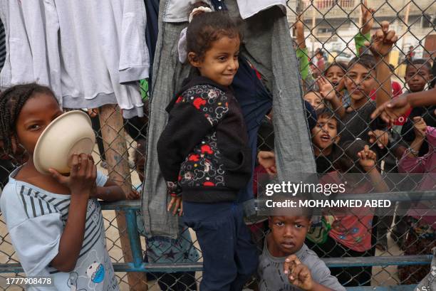 Displaced Palestinian children gather for breakfast at a refugee camp in Rafah in the southern Gaza Strip, on November 12 as battles between Israel...