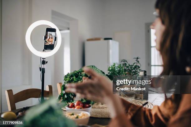 influencer discussing over food in kitchen at home - ring light stock pictures, royalty-free photos & images