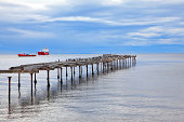 Old dilapidated pier in the Strait of Magellan