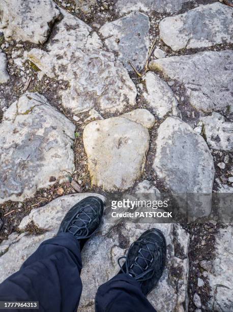 top view of black hiking shoes on the background of stone footpath - tatra national park stock pictures, royalty-free photos & images