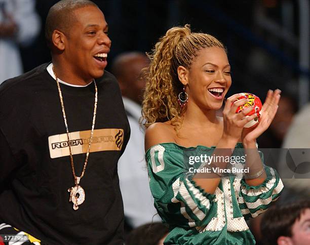 Rapper Jay-Z and singer Beyonce Knowles watch the action during the 2003 NBA All-Star game at the Phillips Arena February 9, 2003 in Atlanta, Georgia.