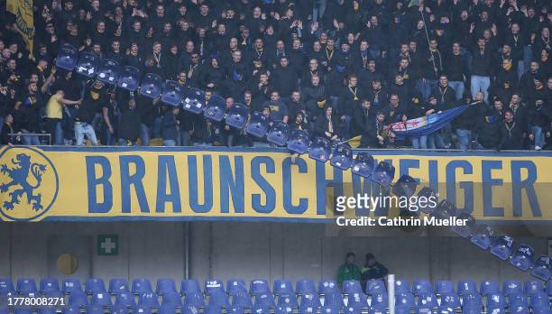 Supporter of Eintracht Braunschweig throw rows of seats from the stands during the Second Bundesliga match between Hannover 96 and Eintracht...