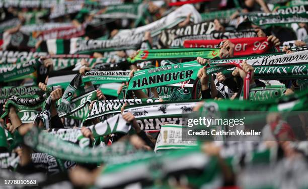 Supporters of Hannover 96 holding holding up their scarves prior to the Second Bundesliga match between Hannover 96 and Eintracht Braunschweig at...