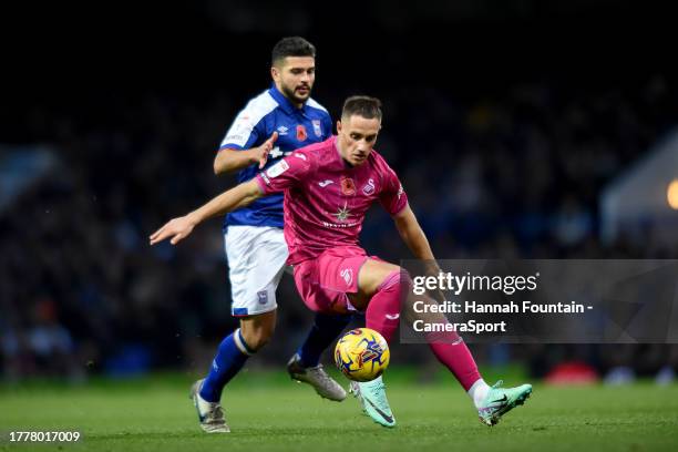 Swansea City's Jerry Yates battles with Ipswich Town's Sam Morsy during the Sky Bet Championship match between Ipswich Town and Swansea City at...