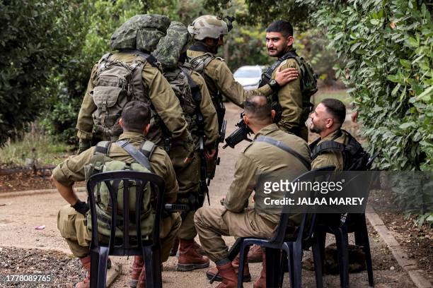 Israeli army officer Kamal Saad , a member of the Druze minority, pats the shoulder of a member of his unit while in an unidentified town in northern...