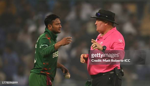 Shakib Al Hasan of Bangladesh and Match Umpire Marais Erasmus interact during the ICC Men's Cricket World Cup India 2023 between Bangladesh and Sri...