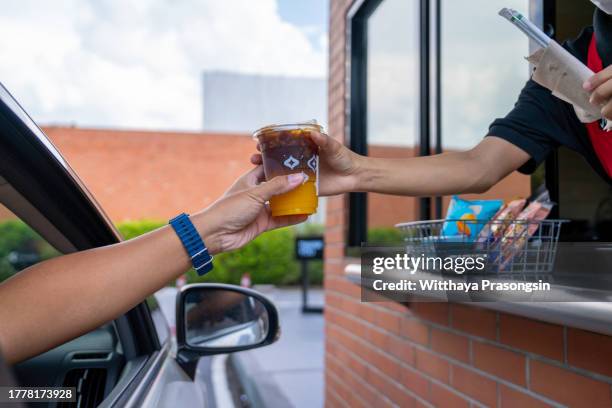 waiter deliver food throght drive thru service - fast food stock pictures, royalty-free photos & images
