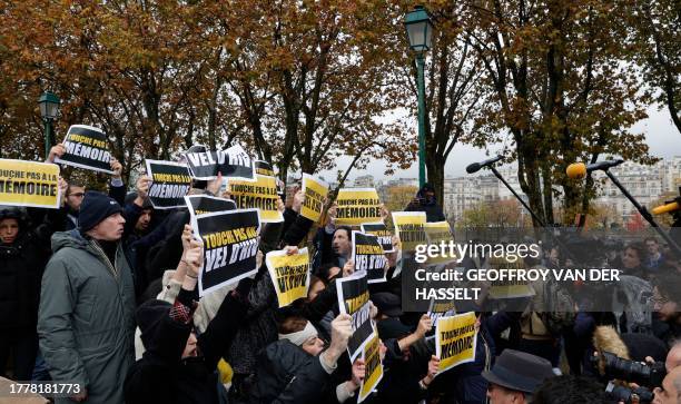 Members of the Jewish community hold placards reading "Don't touch to the Vel d'Hiv " and "Don't tarnish the memory" as they protest a gathering...