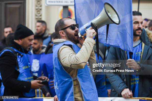 Man with a megaphone during a rally of police unions JUPOL and CEP together with the Civil Guard associations JUCIL and AEGC, in front of the...