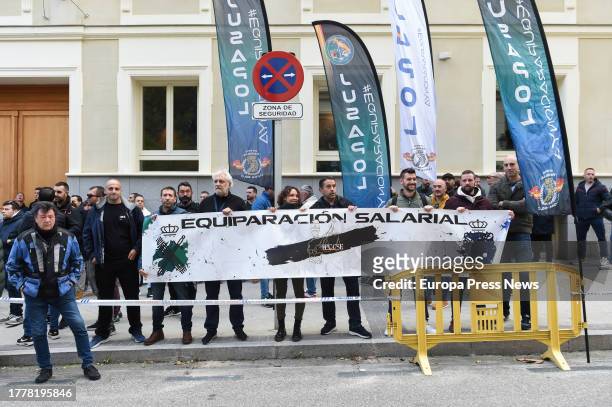 Several people with a banner during a concentration of police unions JUPOL and CEP together with the Civil Guard associations JUCIL and AEGC, in...