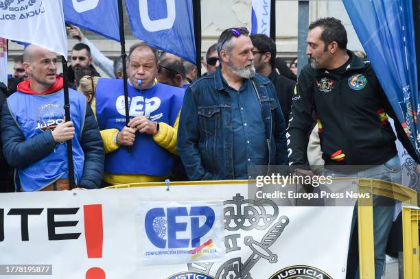 Several people with a banner during a concentration of police unions JUPOL and CEP together with the Civil Guard associations JUCIL and AEGC, in...