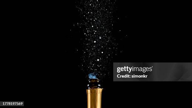 close-up of champagne bottle - champagne bottle popping stock pictures, royalty-free photos & images
