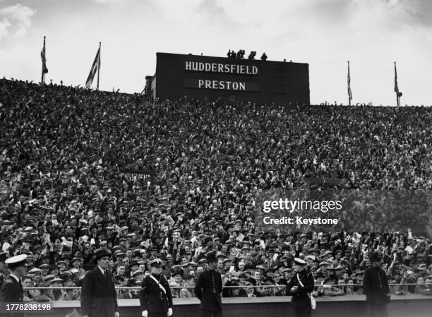 Crowds of supporters in the stands for the FA Cup Final between Preston North End and Huddersfield Town, held at Wembley Stadium in London, England,...