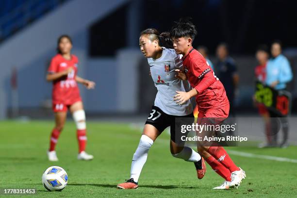 Ena Takatsuka of Mitsubishi Heavy Industries Urawa Reds Ladies and Li Chun-Mei of Hualien compete for the ball during the AFC Women's Club...