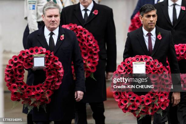 Britain's main opposition Labour Party leader Keir Starmer and Britain's Prime Minister Rishi Sunak bring wreaths during the National Service of...