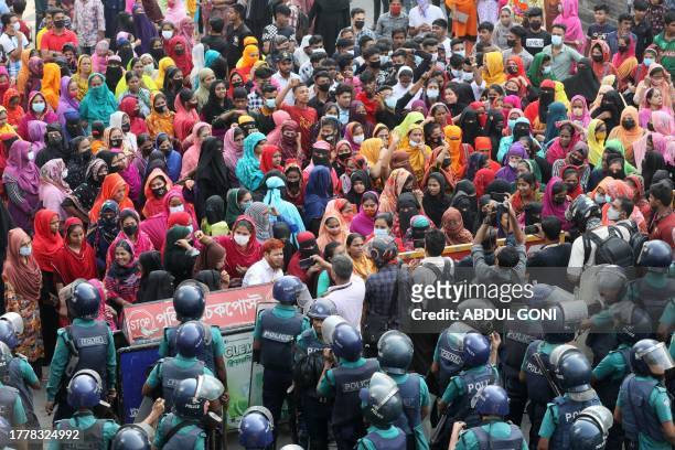 Garment workers block a key intersection as they protest in Dhaka on November 12 demanding a near-tripling of the minimum wage to 23,000 taka ....