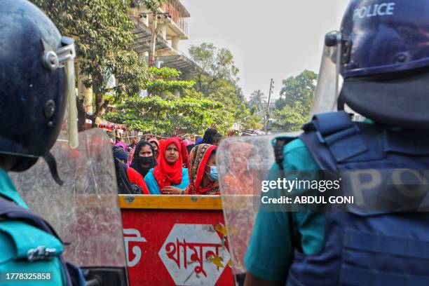 Garment workers block a key intersection as they protest in Dhaka on November 12 demanding a near-tripling of the minimum wage to 23,000 taka ....