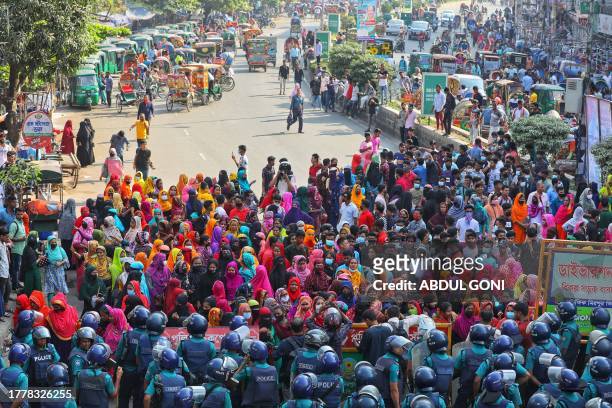 Garment workers block a key intersection as they protest in Dhaka on November 12 demanding a near-tripling of the minimum wage to 23,000 taka ....