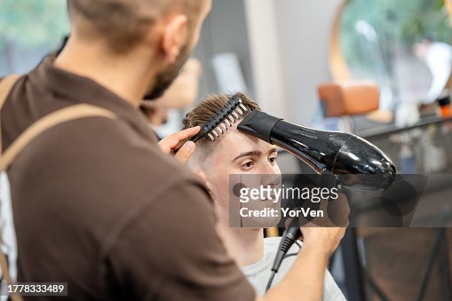 Young Man Receiving A Haircut At The Barber Shop High-Res Stock Photo ...