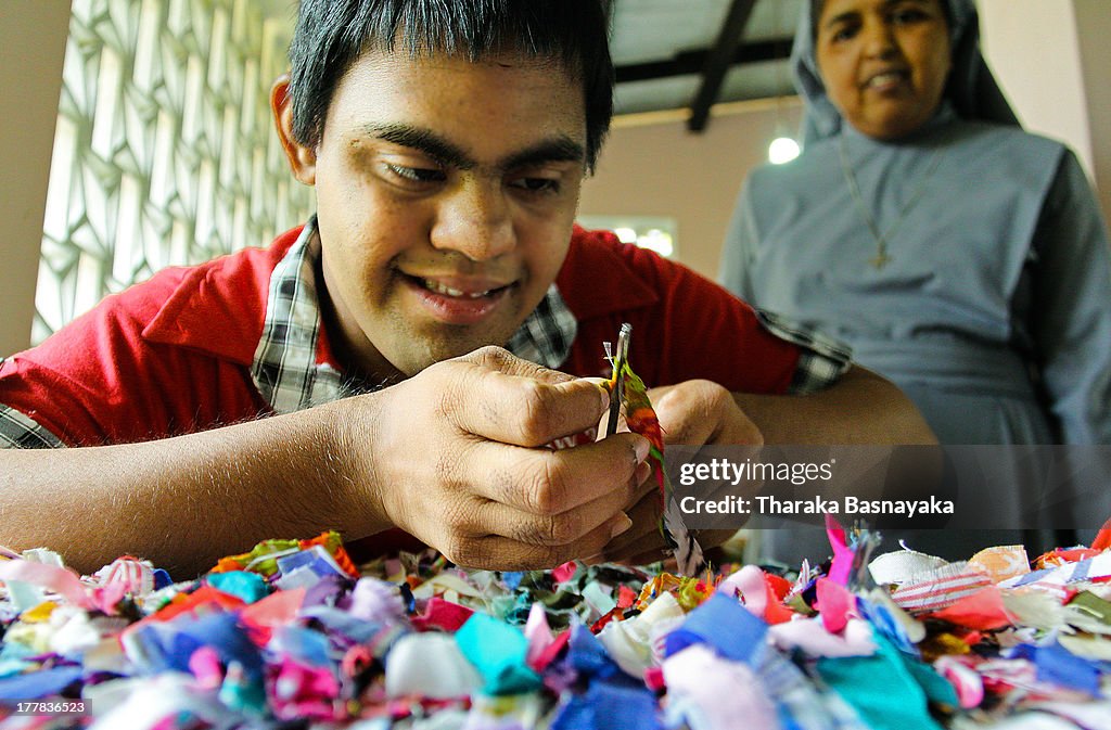 A mentally challenged child threads a needle