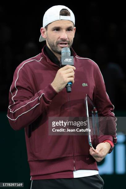 Runner-up Grigor Dimitrov of Bulgaria poses during the trophy ceremony after being beaten by Novak Djokovic of Serbia in the Men's Singles Final on...