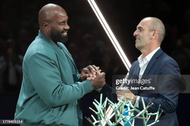 Trophy presenter Teddy Riner and Tournament Director Cedric Pioline during the trophy ceremony after the Men's Singles Final on day 7 of the Rolex...